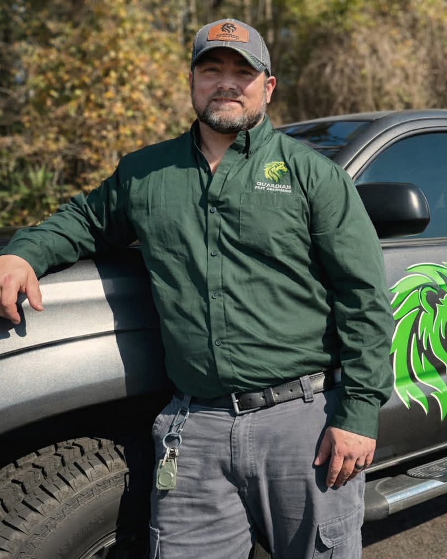 Joshua Walker, owner of Guardian Pest Solutions, standing by his company truck